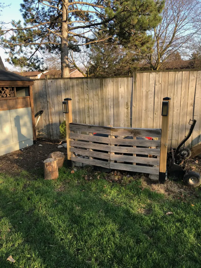 Make a privacy fence from wood pallets to hide stuff