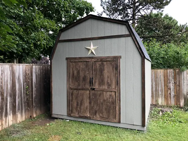 new shed on crappy lawn full of weeds